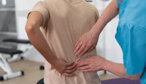 Doctor examining a patients spine.