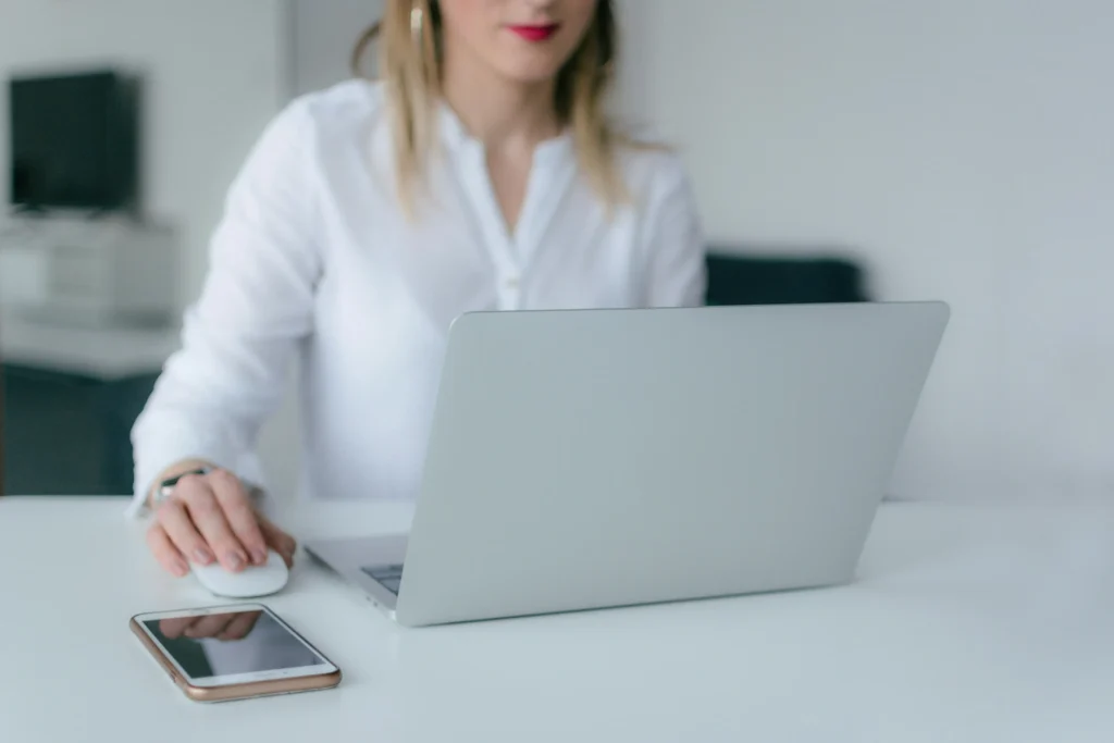 A person sitting in front of a laptop.