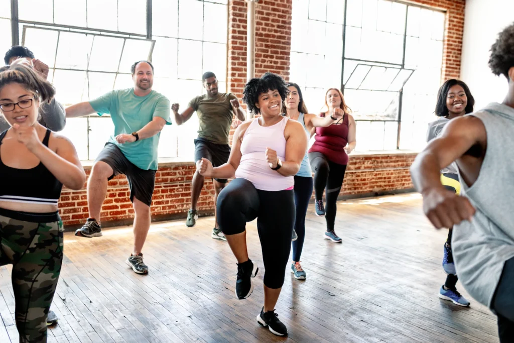 A group exercising in a gym setting.